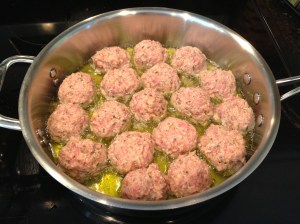 Meatballs just getting started. Turn over when browned.